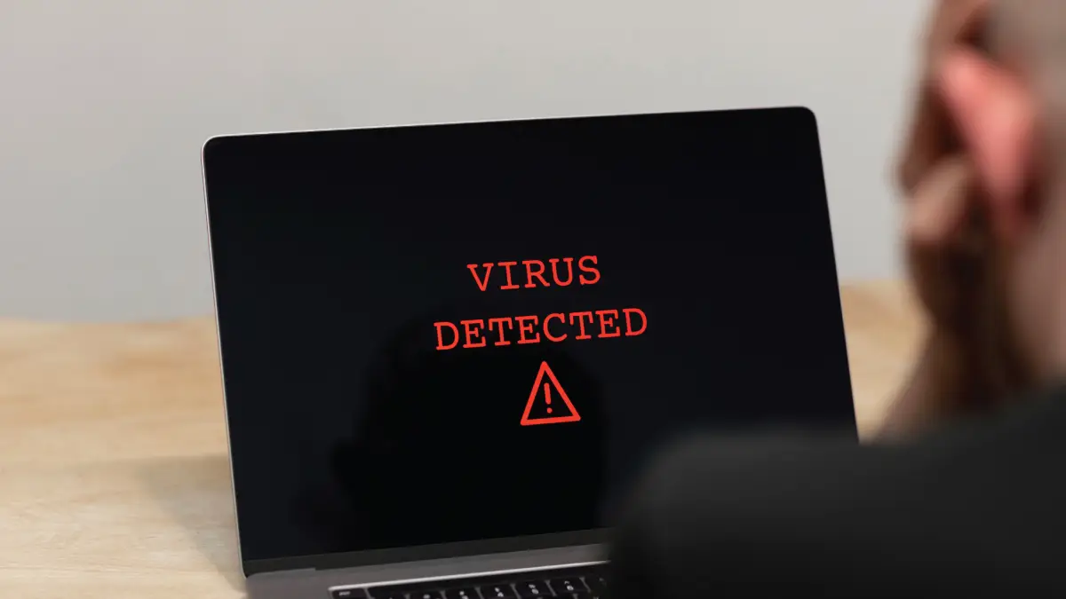 Virus removal guide illustration for Windows users showing antivirus scan on laptop