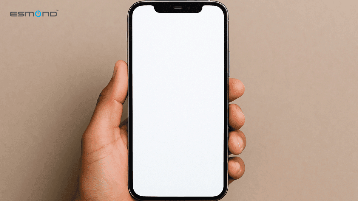 Close-up of an iPhone stuck on a white screen, commonly known as the White Screen of Death (WSOD), held in a person’s hand.