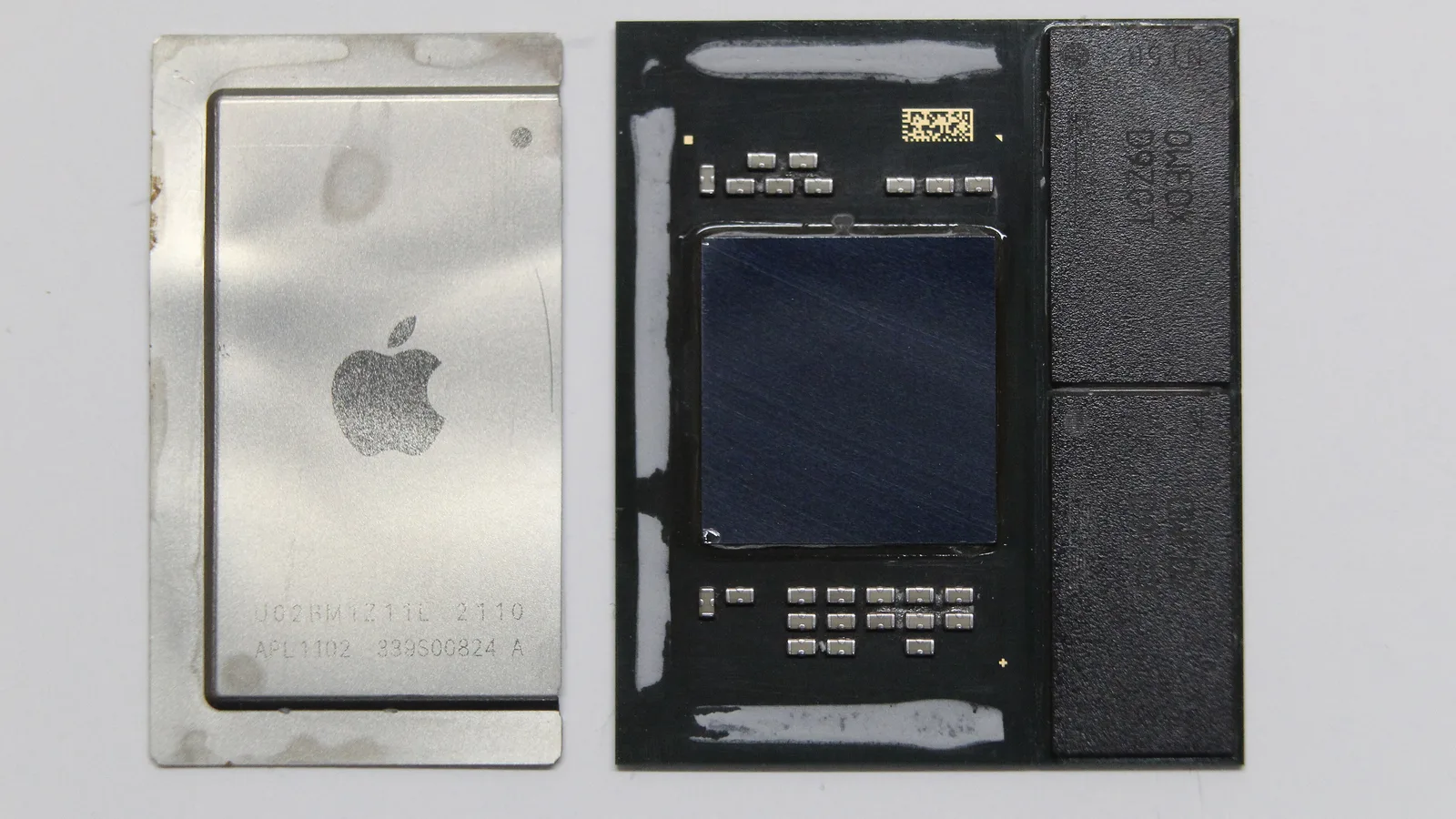 An Apple chip taken apart on a white surface: its silver lid with the Apple logo and the marking APL1102 on the left, and the dark chip package on the right with the bare square die in the middle and two black chips beside it