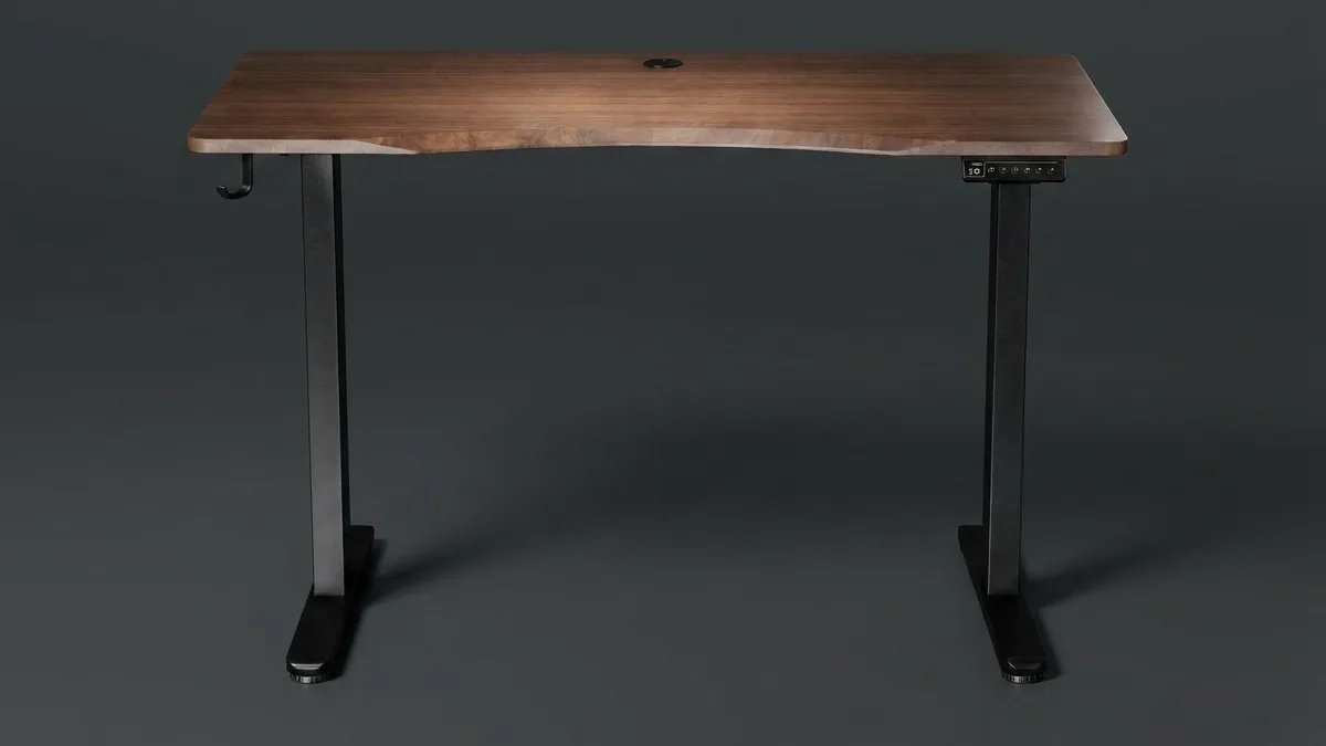 The Vival dual-motor standing desk: a walnut top with a cable grommet, two black column legs, a multi-button controller under the right edge, a headphone hook on the left leg and levelling feet
