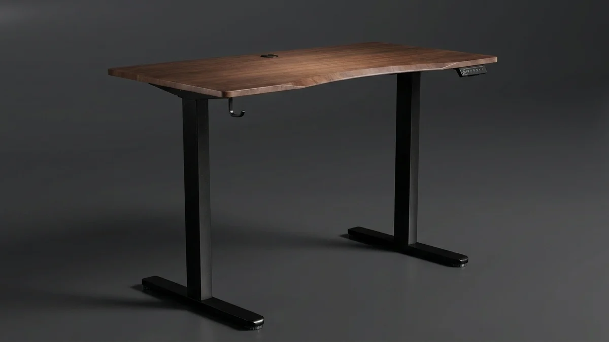 The Vival dual-motor standing desk on a plain dark studio background, its contoured walnut top on a black two-column frame, with the controller under the right-hand edge and a cable hook on the left.