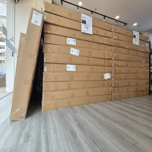 Ready stock of Vival Standing Desk in Singapore – boxed units stacked for fast delivery.